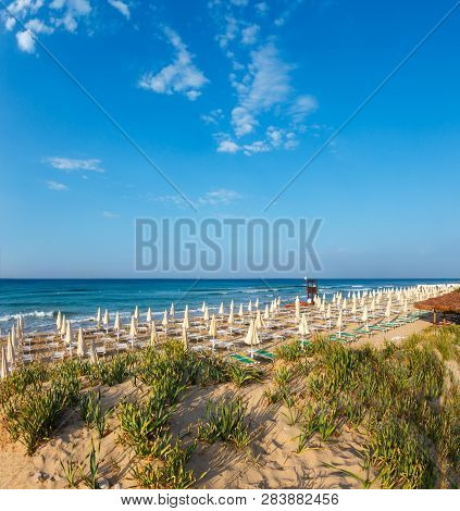 Morning Paradise White Sandy Beach With Sunshades And Sunbeds (salento, Puglia, South Italy). The Mo