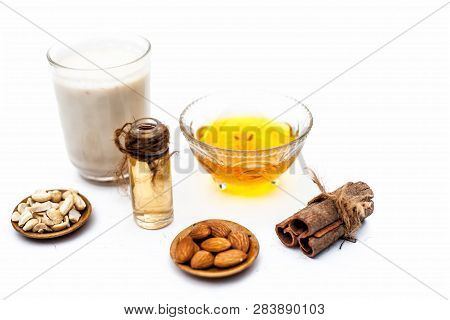 Close Up Of Popular Indian & Asian Winter Drink Isolated On White I.e Honey Milk Or Shahad Ka Dudh I
