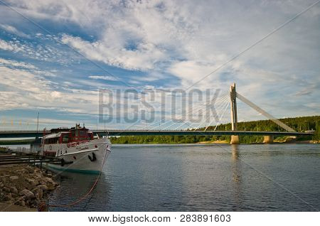 Rovaniemi/finland - 27 June 2009: Dusk View Of The Rovaniemi Bridge And Ferry Boat