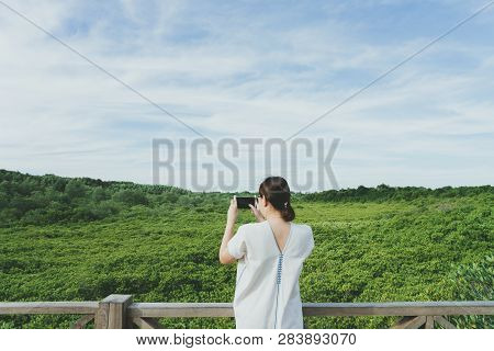 Beautiful Young Tourists Stand Admiring Mangrove Forest (ceriops Decandra) Also Known As The Golden 