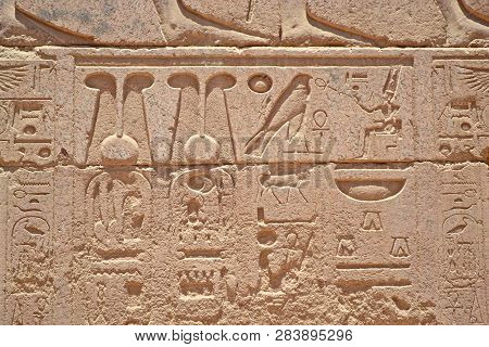 Egyptian Hieroglyphs, Symbols And Signs On A Stone Wall In Karnak Temple. Elements And Details Of Ba