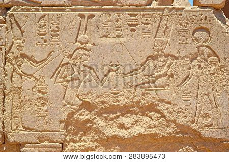 Egyptian Hieroglyphs, Symbols And Signs On A Stone Wall In Karnak Temple. Elements And Details Of Ba