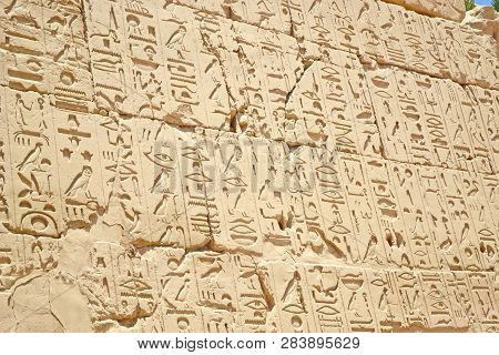Egyptian Hieroglyphs, Symbols And Signs On A Stone Wall In Karnak Temple. Elements And Details Of Ba