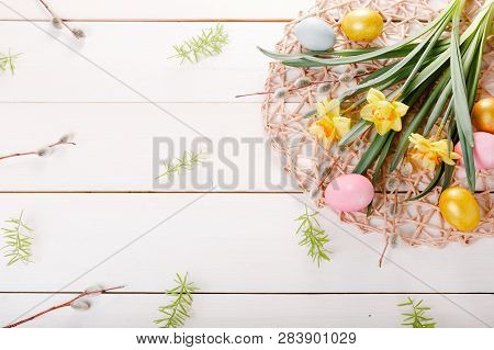 Easter Background With Easter Eggs And Spring Flowers. Top View With Copy Space