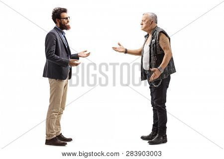 Full length profile shot of a bearded man having a conversation with an angry male punker in a leather vest isolated on white background