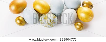 Easter Background With Easter Eggs And Spring Flowers. Top View With Copy Space