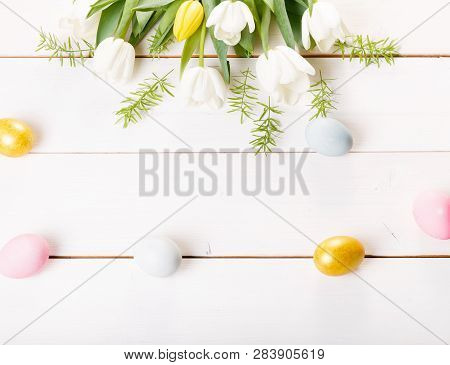 Easter Background With Easter Eggs And Spring Flowers. Top View With Copy Space