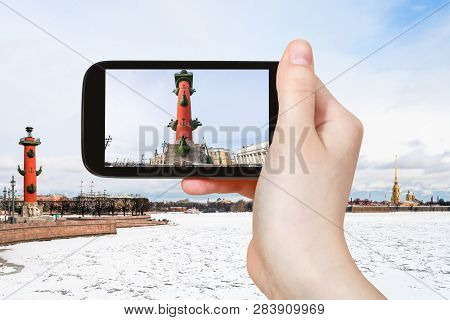 Travel Concept - Tourist Photographs Of Rostral Column On Birzhevaya Ploschad Square In Saint Peters