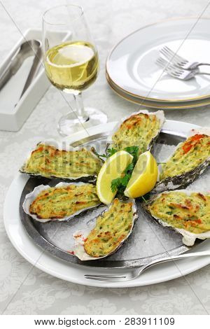 oysters rockfeller, baked oysters on half shell topped with green sauce and bread crumbs