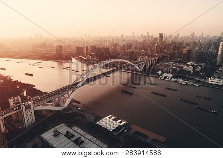 Shanghai Lupu Bridge aerial view over Huangpu River at sunset in China
