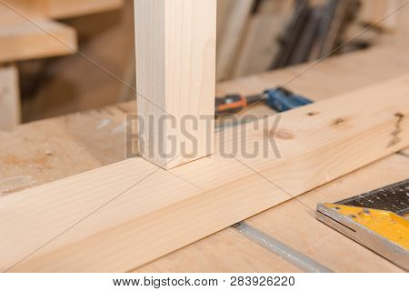 A Man Is Screwing A Screw Into A Wooden Table. Carpentry Workshop. Work With A Screwdriver.