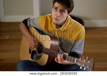 The Guy In The Yellow Sweater Plays The Guitar And Sings A Sad Song, Sitting At Home
