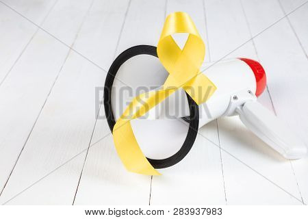 Yellow Ribbon Symbolic Color For Sarcoma Bone Cancer Awareness And Suicide Prevention On Aged Wood W
