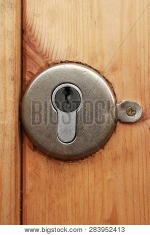 Mortise Round Lock With Keyhole Embedded In A Wooden Door