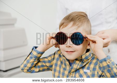 Ophthalmologist Tests Child Kid Boy For Color Blindness, Eye Vision Test.
