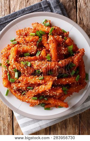 Asian Honey Chilli Potato Wedges With Hot Sweet Sauce, Sesame And Green Onions Close-up. Vertical To