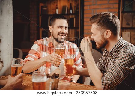 Two Bearded Young Men Plaid Shirts Relax Bar, Laugh, Tell Funny Stories, Drink Draught Beer In Pub, 