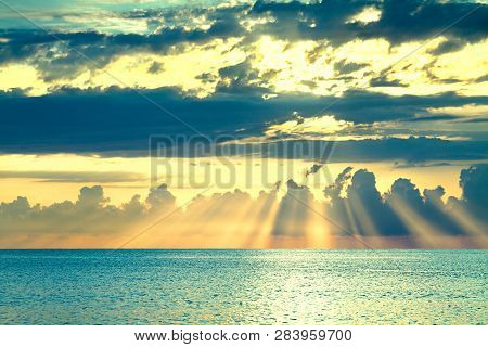 Beautiful Sea Landscape With A Sunset. Evening Sky With Clouds And Sunshine Over Ocean. Sun Rays Shi