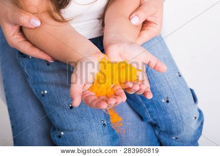 Festival Of Holi And Holidays Concept - Babys Hand With Colored Powder.