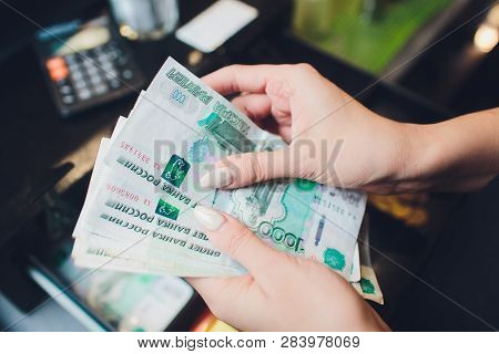 Russian Rubles In The Hand Of A Fan.male Hand Holding Many Of The Russian Banknotes.the Transfer Of 
