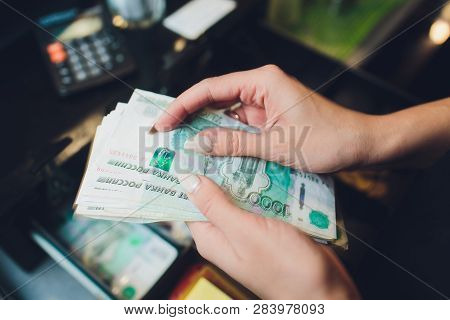 Russian Rubles In The Hand Of A Fan.male Hand Holding Many Of The Russian Banknotes.the Transfer Of 