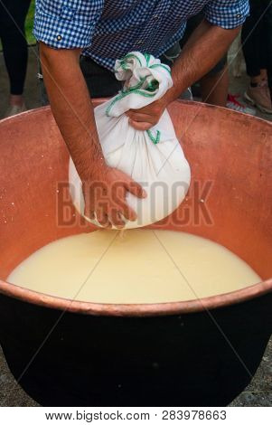 Cheesemaker Showing The Proceeding To Make Cheese From The Milk