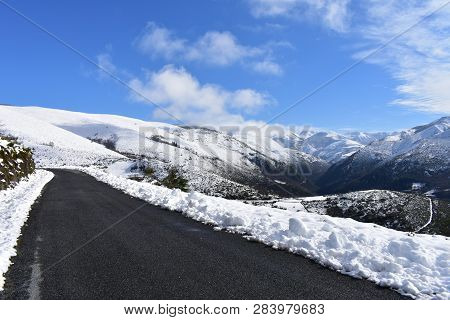 Winter Landscape With Road And Snowy Mountains. Blue Sky With Clouds. Ancares Region, Lugo Province,