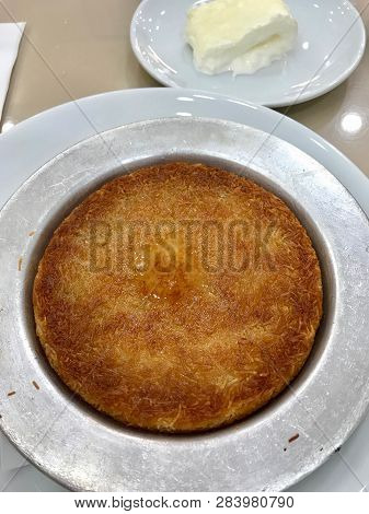 Kunefe, Traditional Turkish Dessert With Kaymak Served At Restaurant.