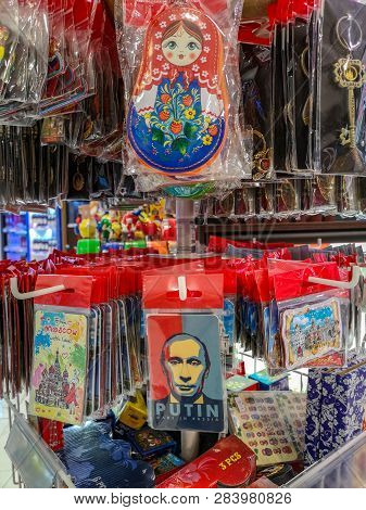 Moscow, Russia - December 2018: Cheap, Plastic Wrapped Souvernirs On A Rack At The Airport.