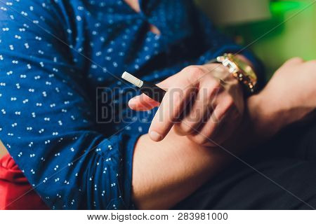 Iqos Heat-not-burn Tobacco Product Technology. Woman Holding E-cigarette In His Hand Before Smoking.