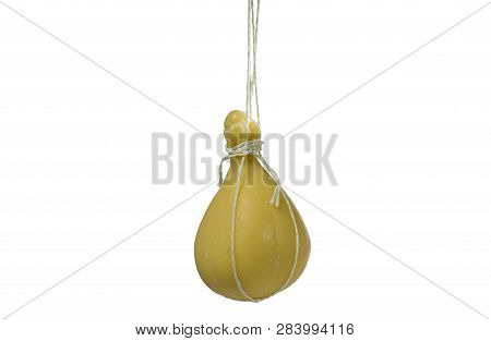 Typical Italian Cheese Caciocavallo Ripens In Ropes In A Hanging State.