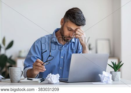 Eyes Fatigue. Overworked Businessman Tired After Long Working Day In Office, Sitting At Workplace, M