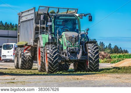 Bavaria / Germany - August 20, 2020: Fendt Tractor With A Loader Wagon, Working On A Biogas Plant