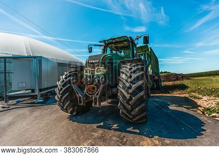Bavaria / Germany - August 20, 2020: Fendt Tractor With A Loader Wagon, Working On A Biogas Plant