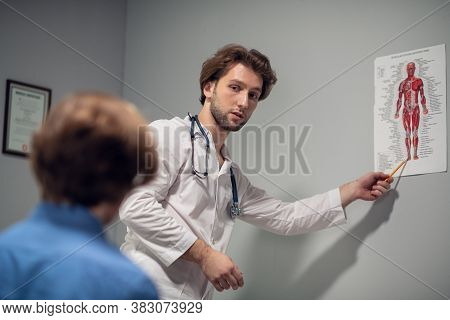 Doctor And Patient Discussing The Check-up Results In A Diagnostic Center.