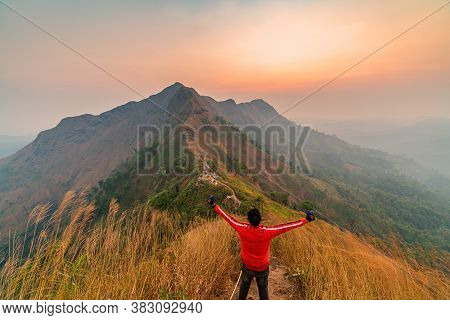 Traveler Man Hiking Enjoying In The Mountains With Backpack At Khao Chang Puak Mountain Thailand