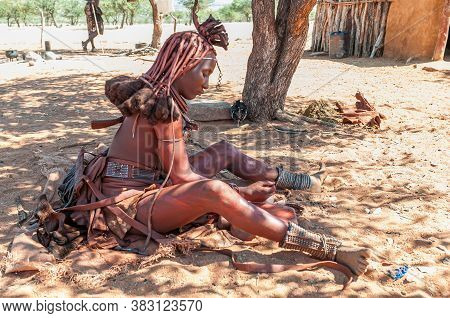 Epupa, Namibia - May 27, 2011: A Married Himba Woman With Traditional Hair Locks And Ornate Headpiec