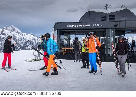 Saalbach, Austria - March 2, 2020: Skiers Going Skiing From Ski Lift Station Steinbergbahn Leogang
