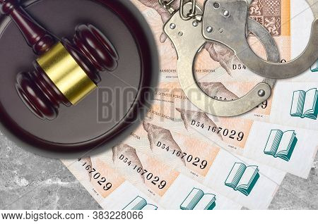200 Czech Korun Bills And Judge Hammer With Police Handcuffs On Court Desk. Concept Of Judicial Tria