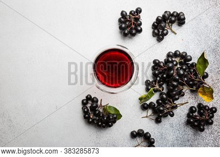 Homemade Black Chokeberry Wine Or Liqueur With Ripe Berries, Top View