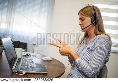 Young Modern Woman Is Working From Home. She Is Having Pain In Palm Of Hand.