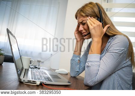 Young Modern Woman Is Working From Home. She Is Having Headache.