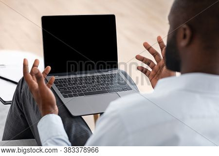 African Man Suffering Problem While Using Laptop With Black Blank Screen Indoors, Over Shoulder View