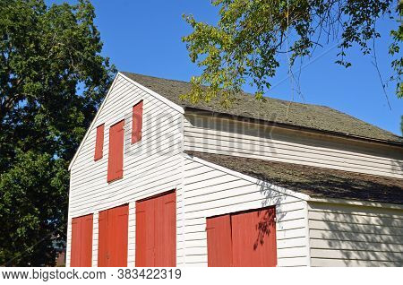 NATCHEZ, MS - August 24, 2020 Located in the Natchez National Park, the carriage house at Melrose estate, part of one of the most intact antebellum properties in the South, pops with red painted doors against white walls.
