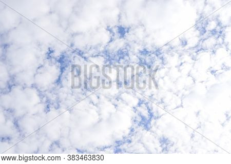 Upward View Of Beautiful White Fluffy Clouds On Vivid Blue Sky