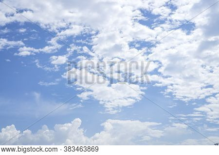 Upward View Of Beautiful White Fluffy Clouds On Vivid Blue Sky