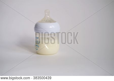 The Electric Breast Pump Is On The Table In The Kitchen. Breast Pump With Milk. Give Expressed Breas
