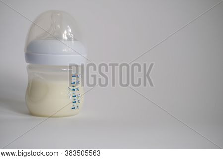 The Electric Breast Pump Is On The Table In The Kitchen. Breast Pump With Milk. Give Expressed Breas