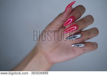 Female Hands With Extended Colored Nails Close-up.