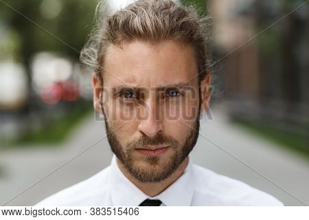 Portrait Of A Handsome Curly-haired Man, In A Business Style. The Astute Look Of An Attractive Busin